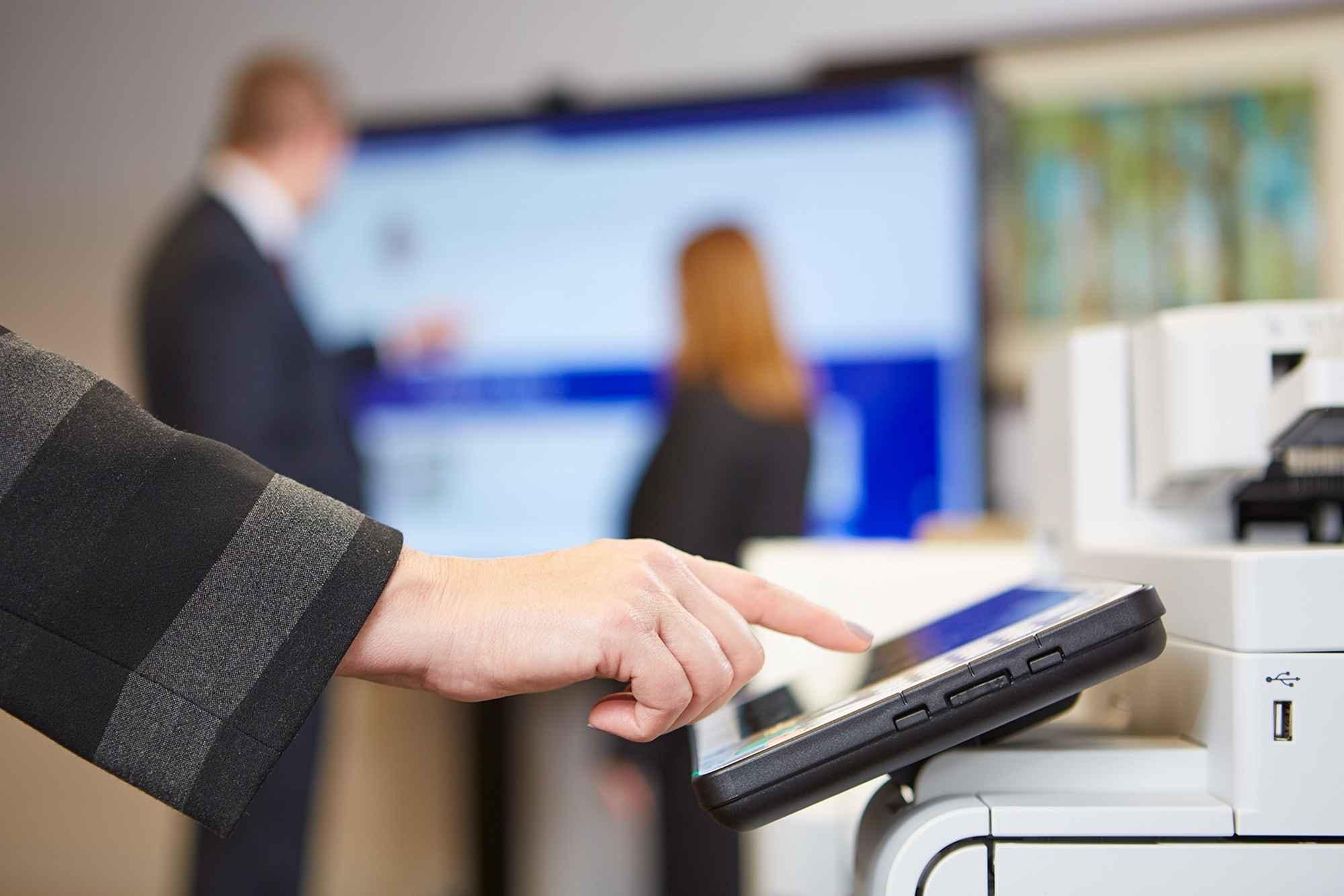 hand-interacting-with-touch-screen-on-printer hand-interacting-with-touch-screen-on-printer